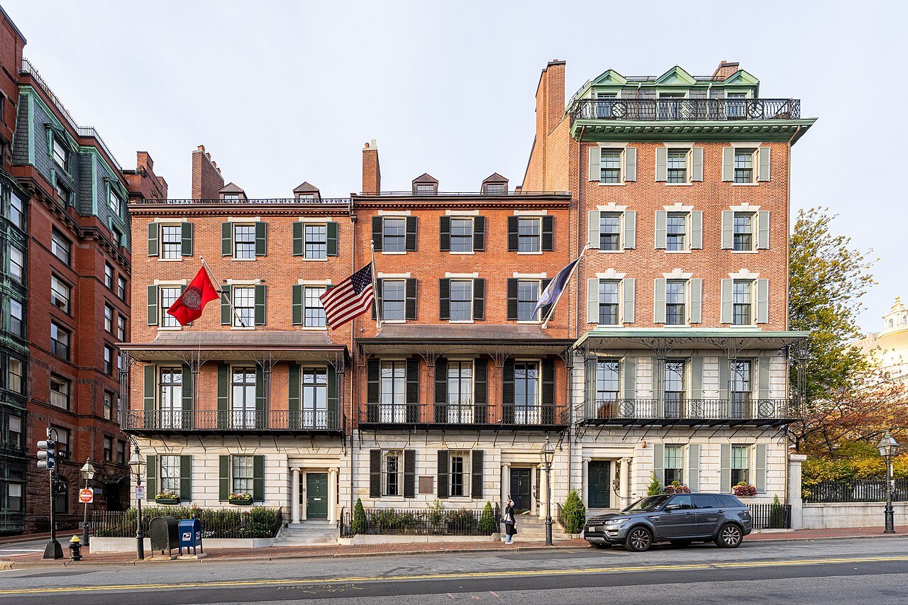 Brick townhouses on Beacon Street, flags hung over their doorways
