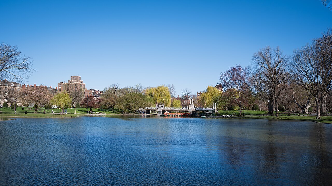 The Public Garden lagoon under a clear spring sky, the bridge far across the water