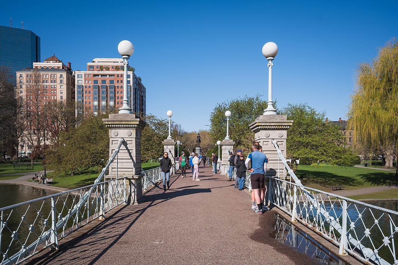 Crossing the lagoon bridge between its lamp posts and white iron railings