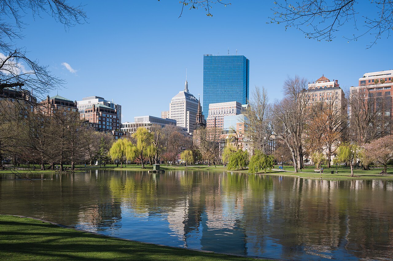 The Back Bay skyline mirrored in the still water of the Public Garden lagoon