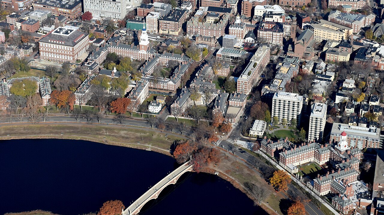 Harvard's river houses beside the Charles, seen from the air with a bridge over the water
