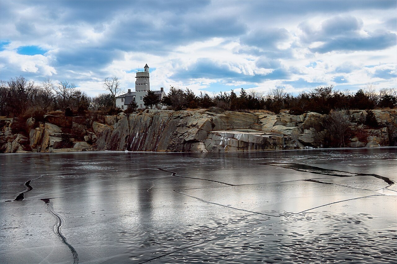 The frozen granite quarry at Halibut Point State Park, the old lookout tower beyond