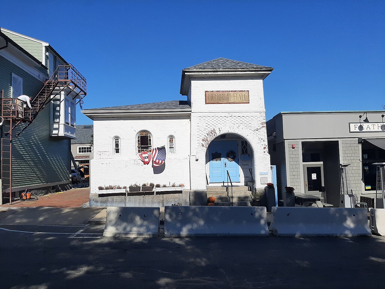 Memorial Hall in Rockport, its arched white gateway under a blue sky