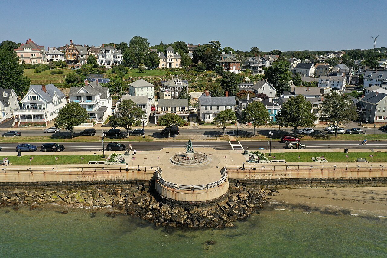 The Gloucester Fisherman's Memorial on its round platform above the harbor, seen from the air