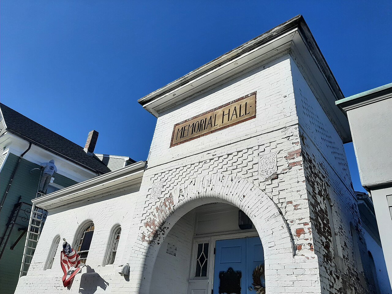 The arched white gateway of Memorial Hall in Rockport