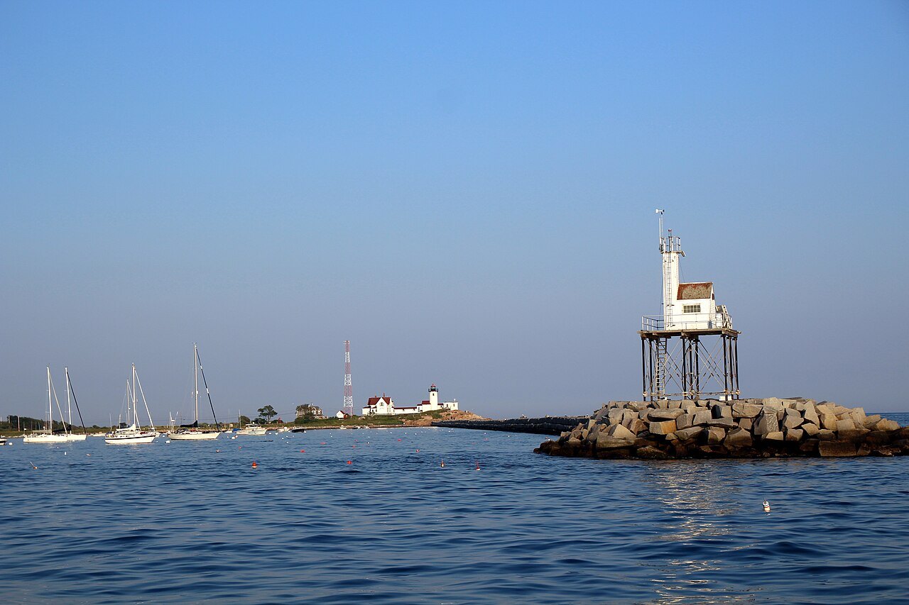 A small light on a steel frame at the end of the granite breakwater off Eastern Point