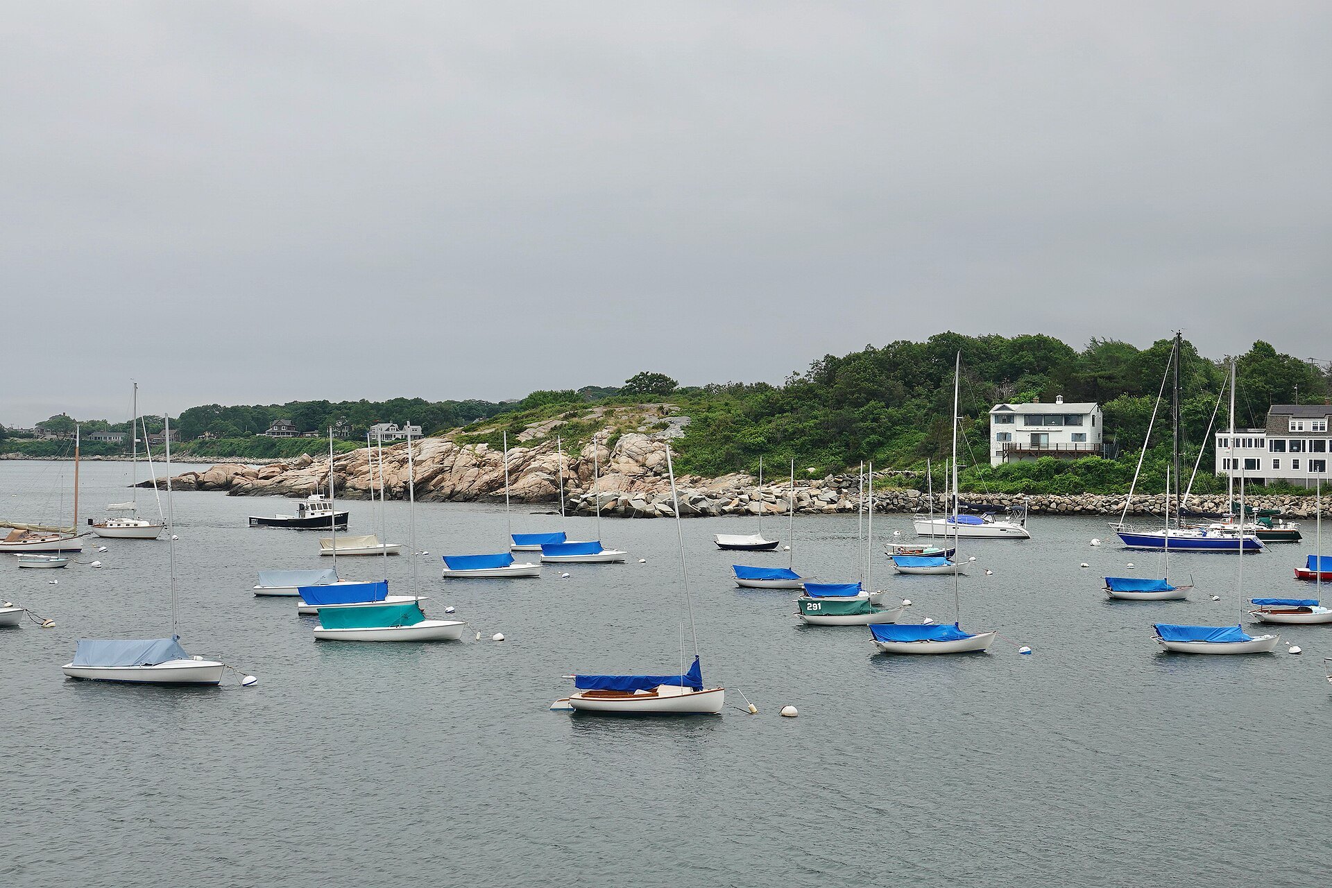 Small boats moored in Rockport's outer harbor under a gray sky