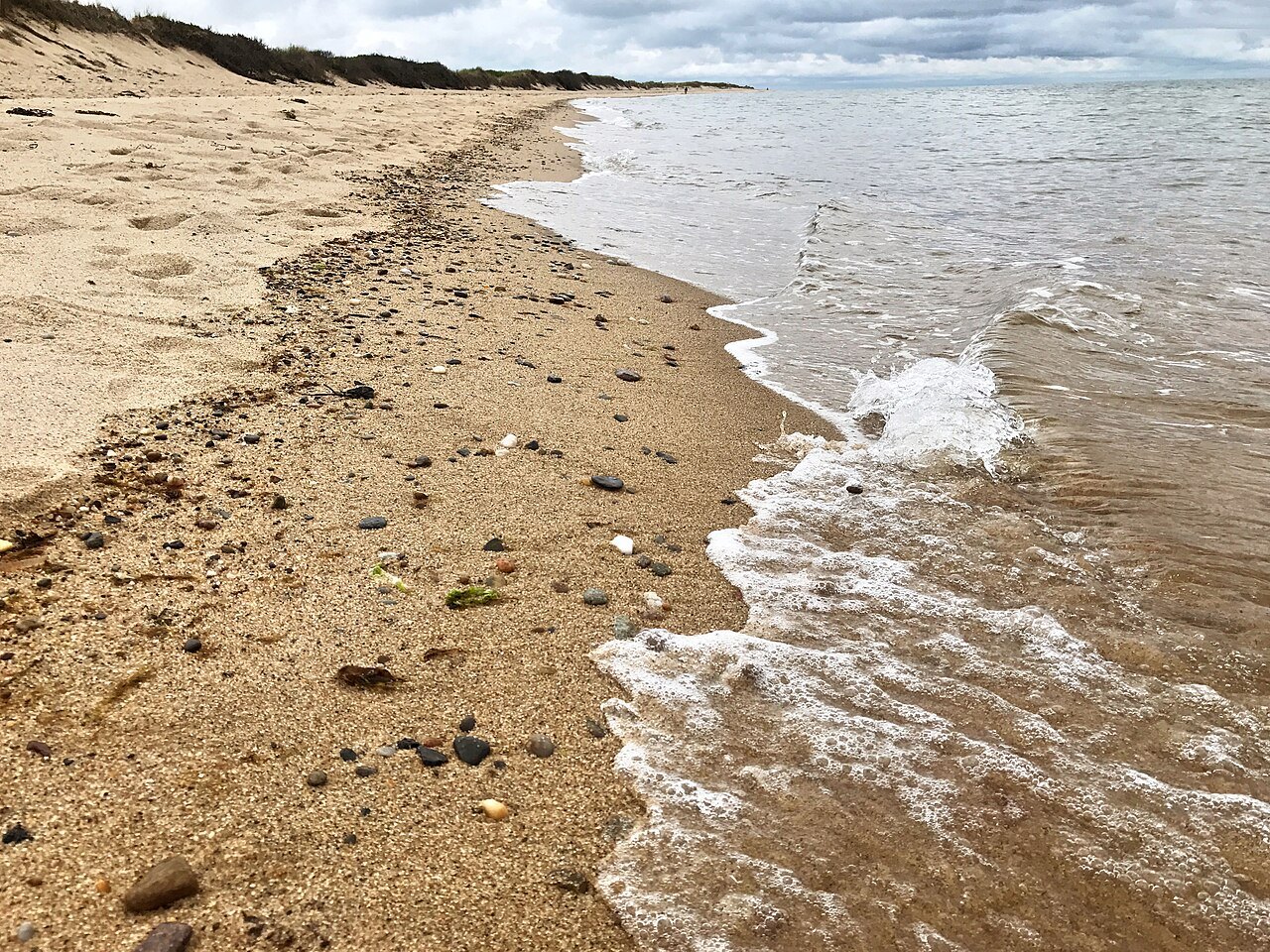 Surf running up over pebbles and sand at Herring Cove