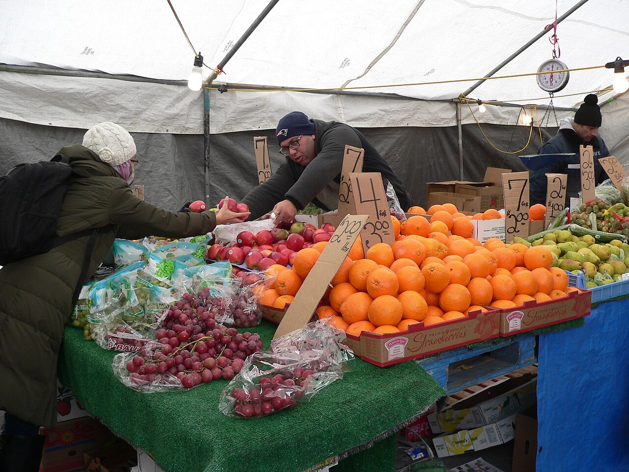 Apples and oranges piled high on a Haymarket cart