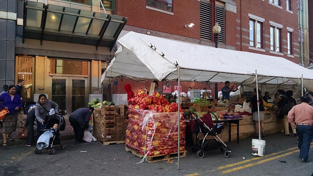 Fruit and vegetable stalls under awnings at Haymarket