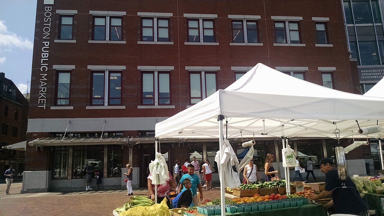 A farmers market under white tents outside the Boston Public Market