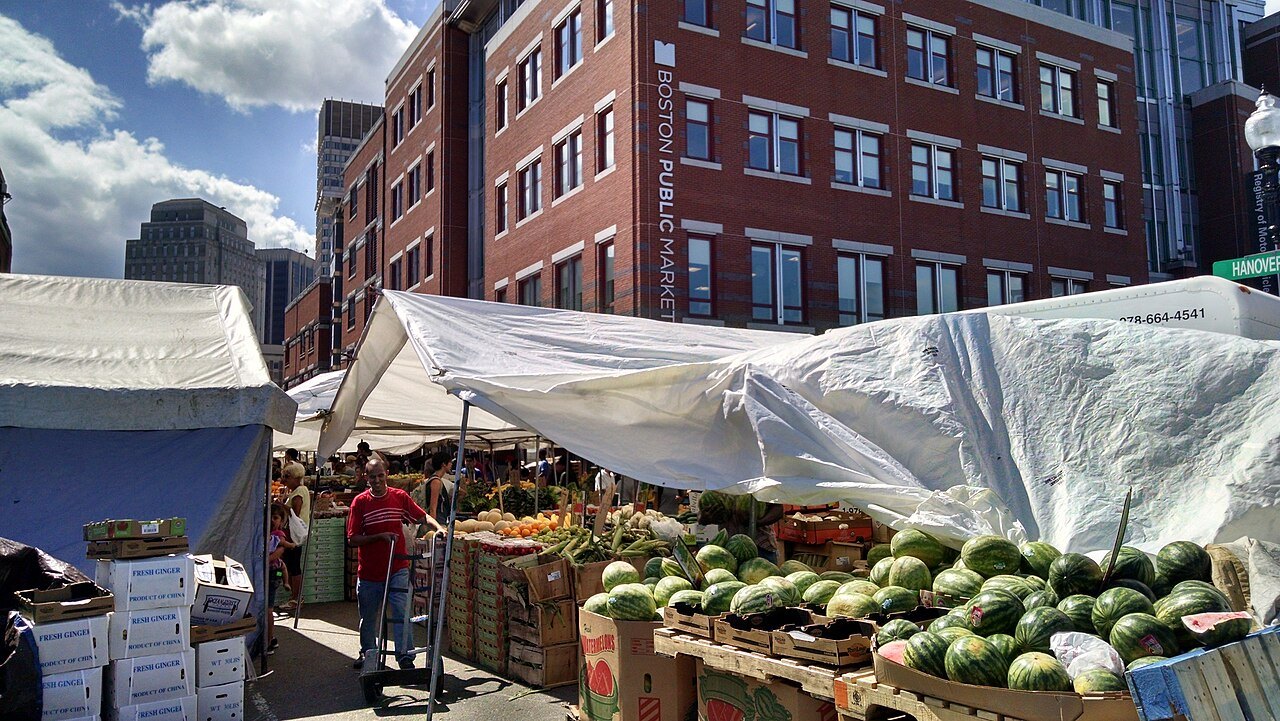 Watermelons and produce under tarpaulins at the Haymarket stalls