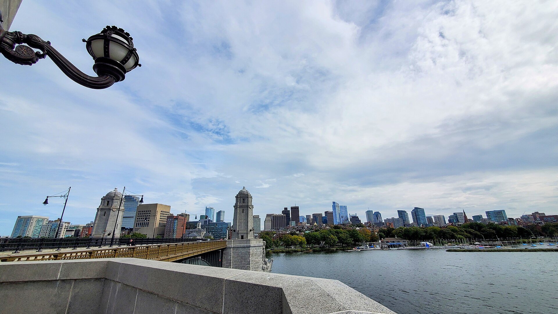 The Boston skyline over the river from the Longfellow Bridge, an old lamp in the foreground