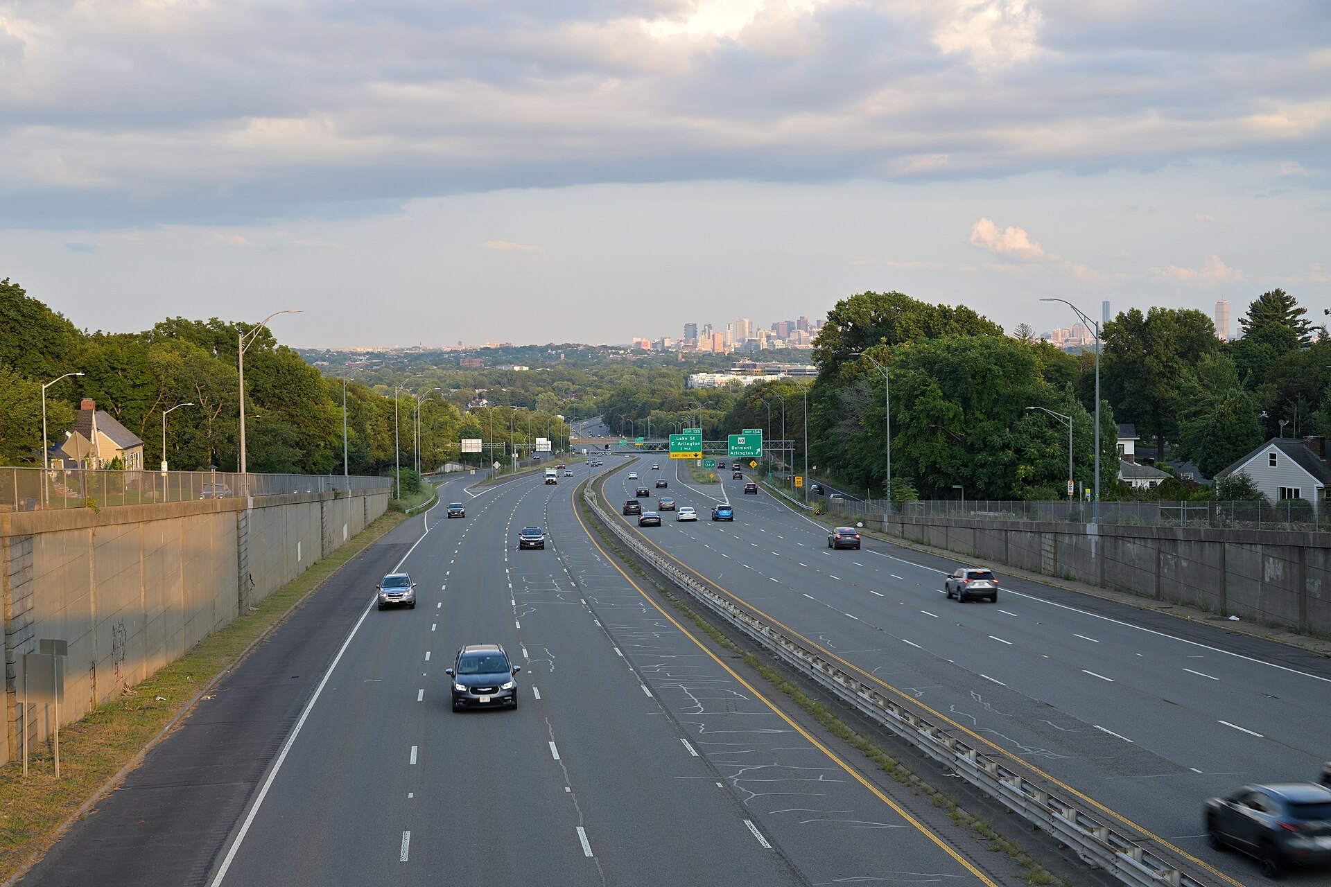 Route 2 running east toward the Boston skyline through green woods