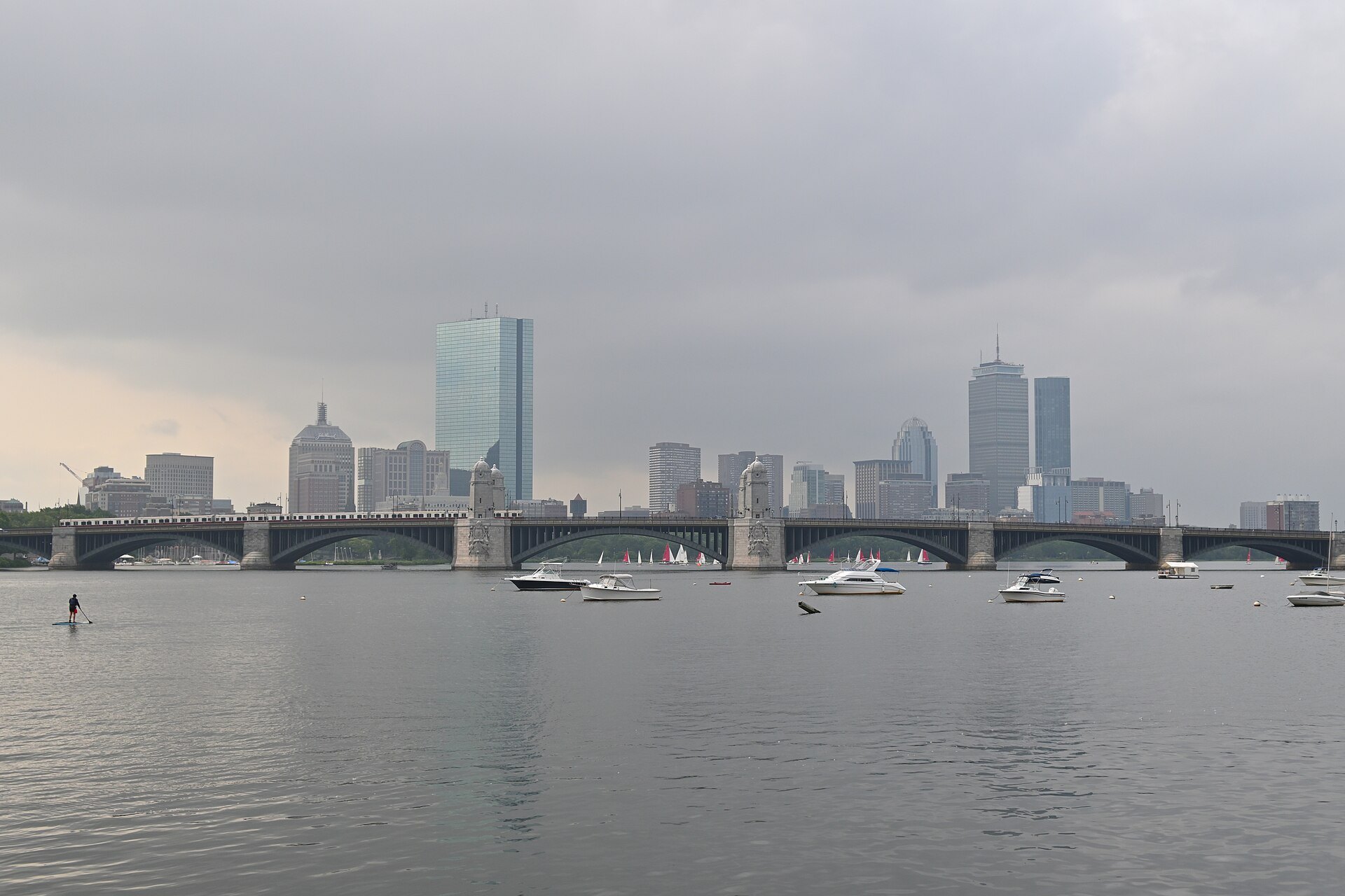 The Longfellow Bridge and the Back Bay towers under a gray sky across the Charles