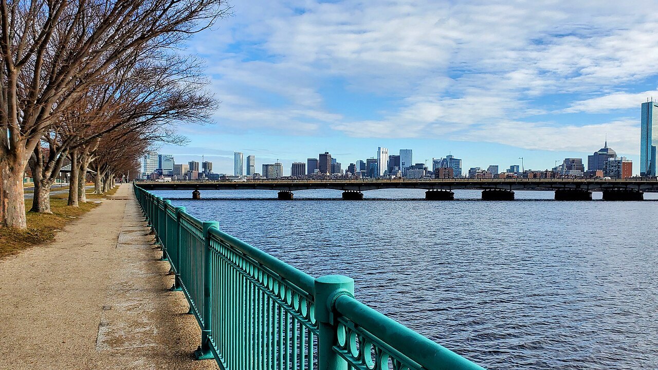 The river path and railings along the Charles, the bridge and the city beyond