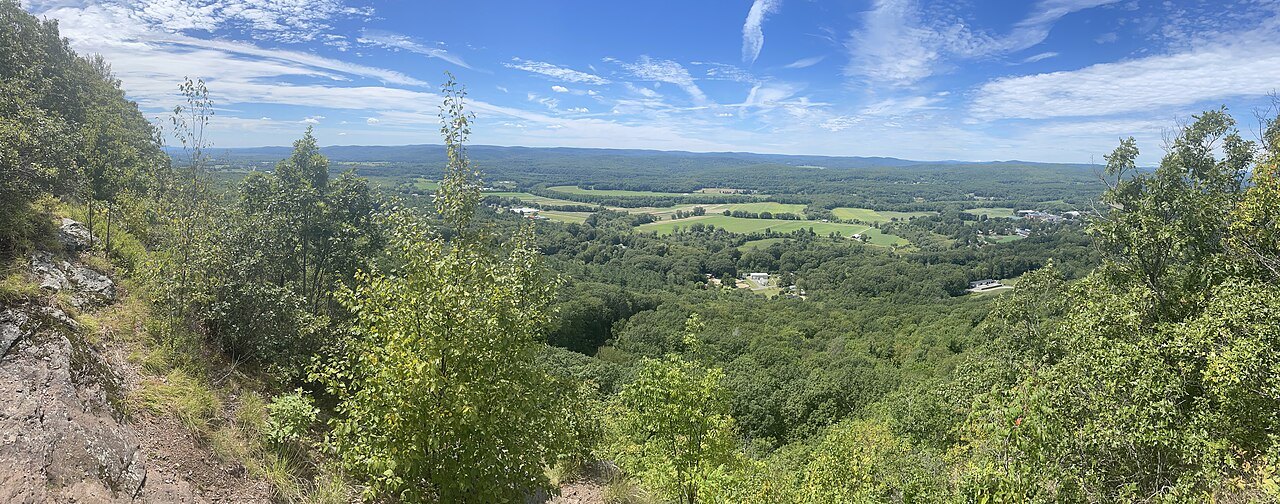 The farms of the Deerfield valley spread below Pocumtuck Rock