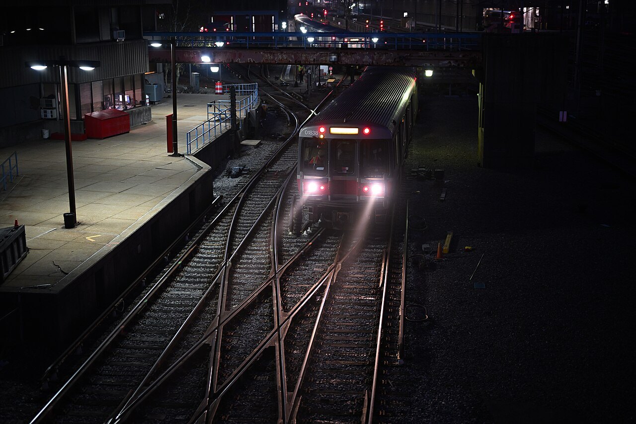 A Red Line train in the yard at dusk