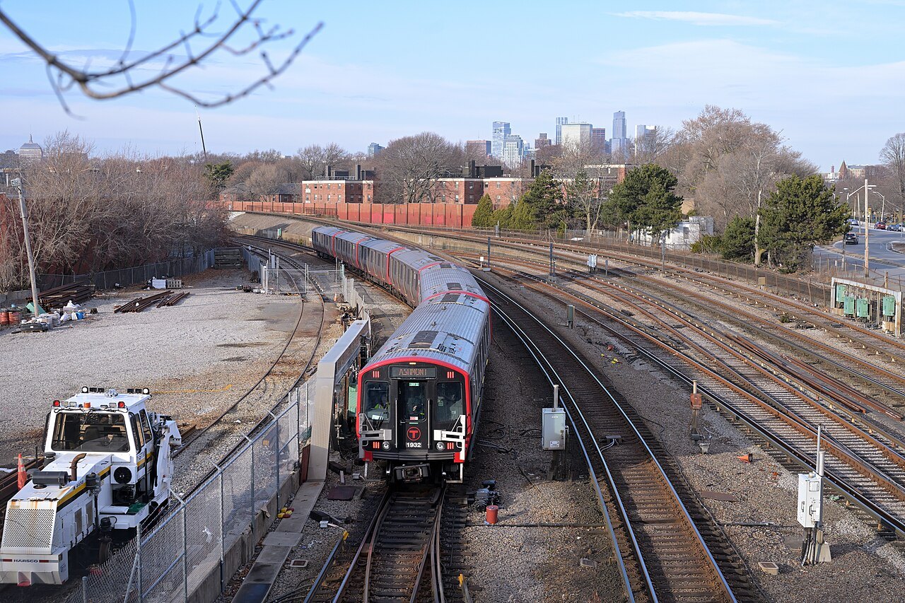 A Red Line train curving toward JFK/UMass station