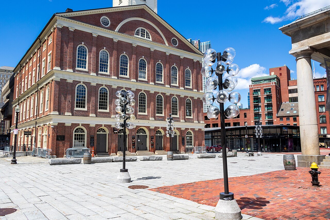 Faneuil Hall across its broad paved plaza on a bright spring day