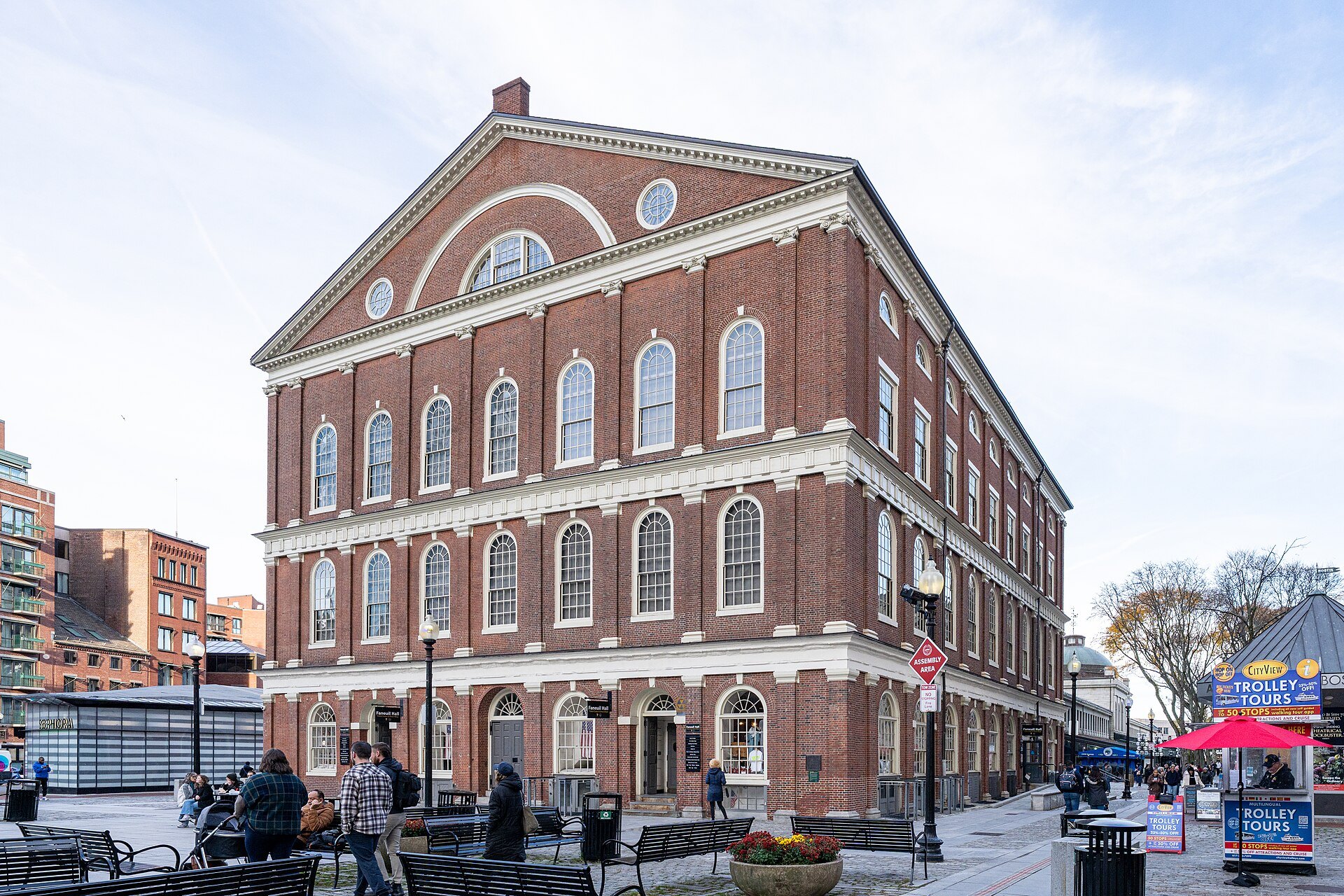 Faneuil Hall on Dock Square, its brick walls, tall arched windows and white cupola