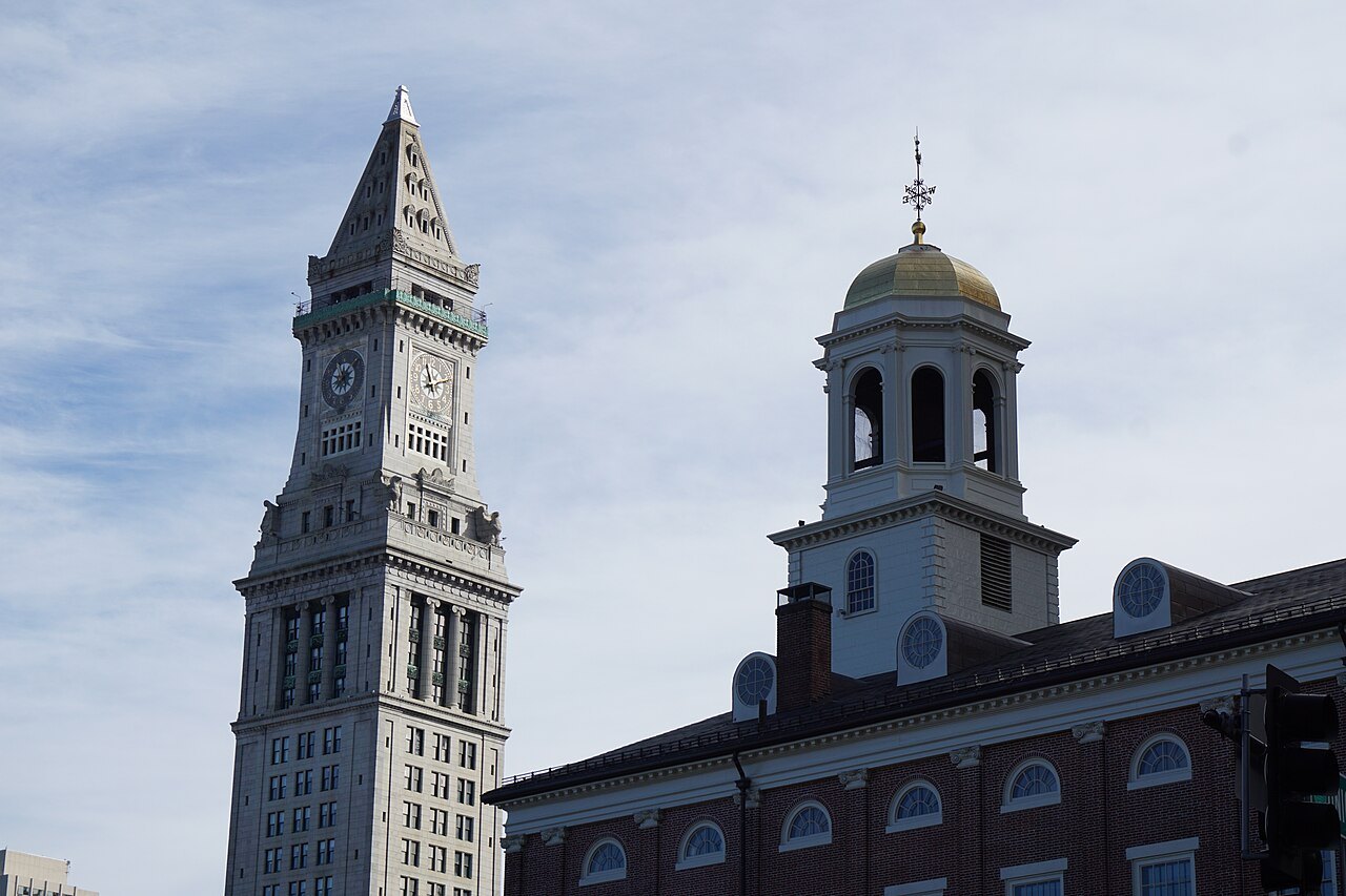 The Custom House tower and the cupola of Faneuil Hall side by side against the sky