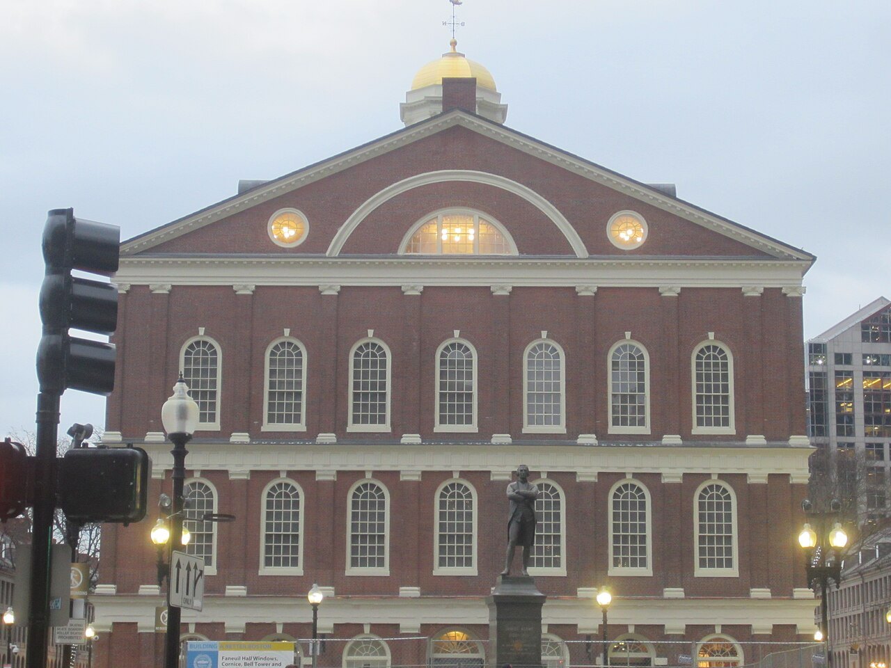 The gable end of Faneuil Hall with its fan window, a statue on the square before it