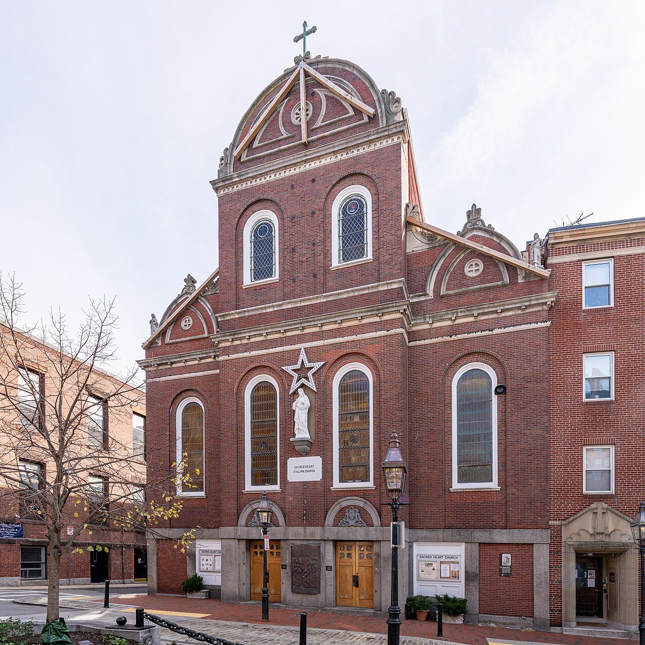 Sacred Heart Church in North Square, a cross above its brick front