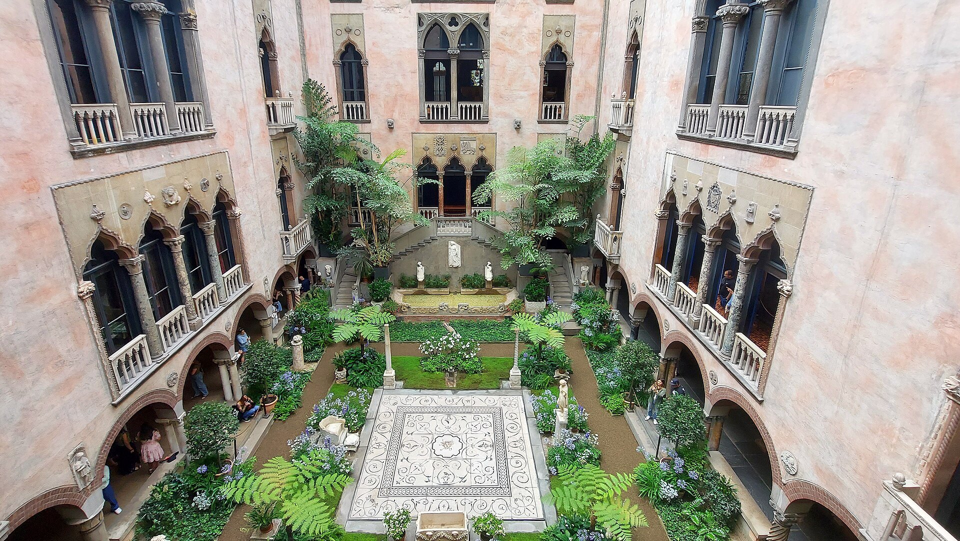 The glass-roofed courtyard of the Gardner, Venetian windows and balconies above a Roman mosaic floor