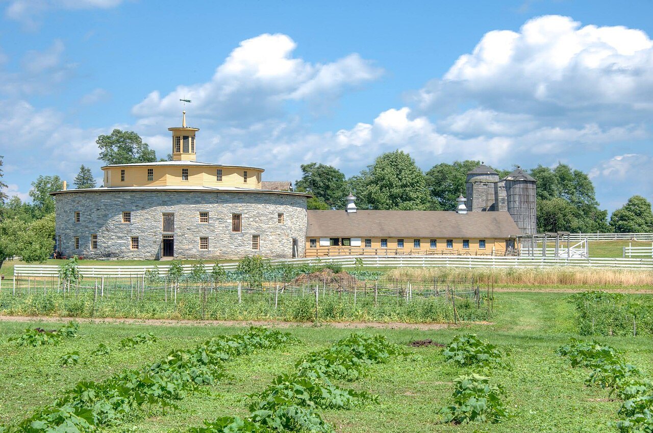 The Round Stone Barn beyond the village's vegetable gardens