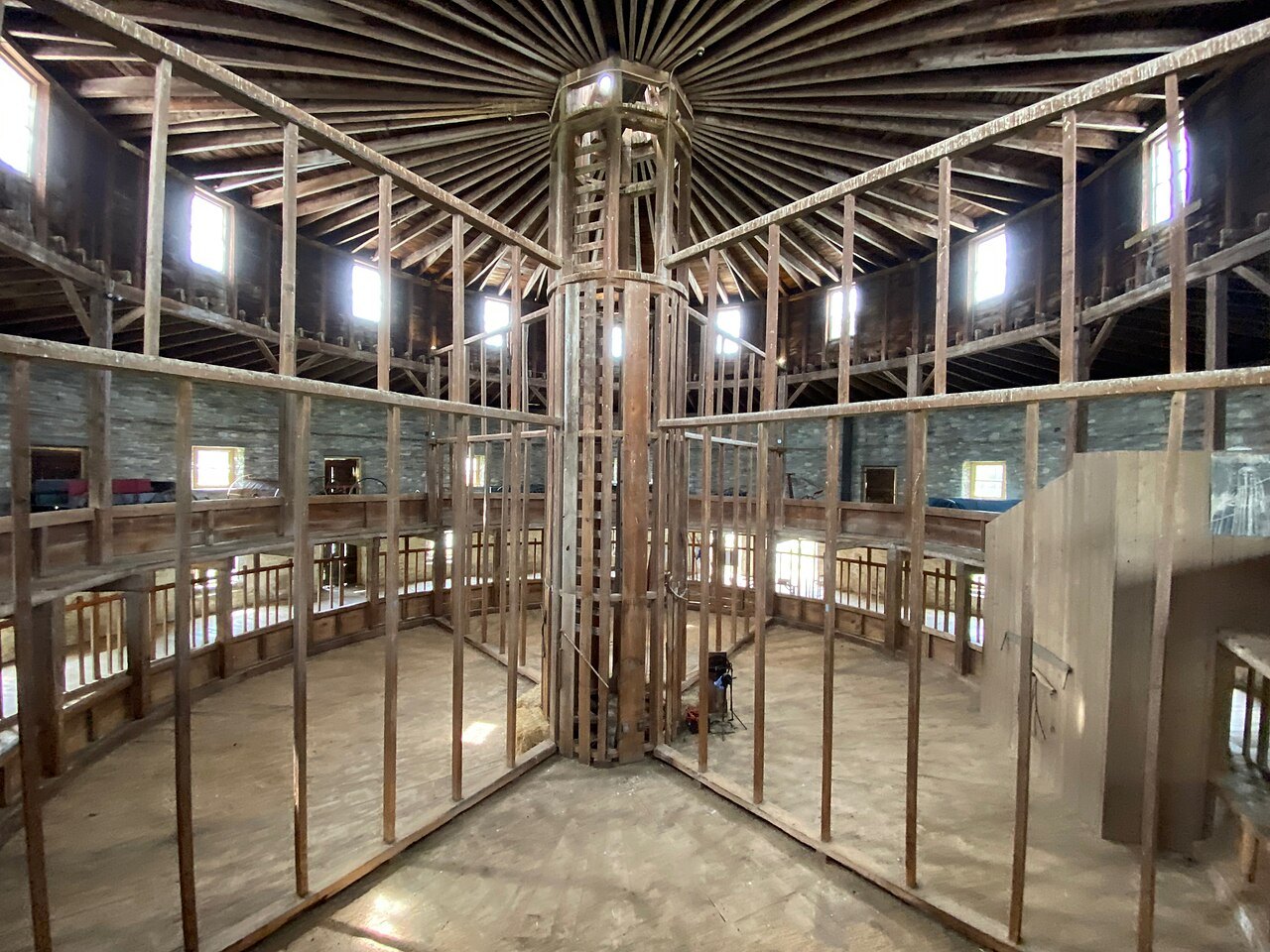 Inside the Round Stone Barn, the timber framing rising around the central shaft