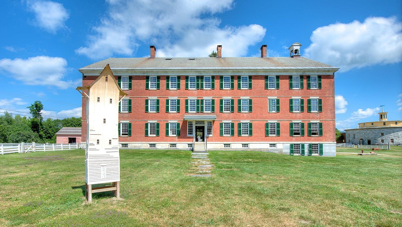 The Brick Dwelling of 1830, long rows of windows facing the lawn