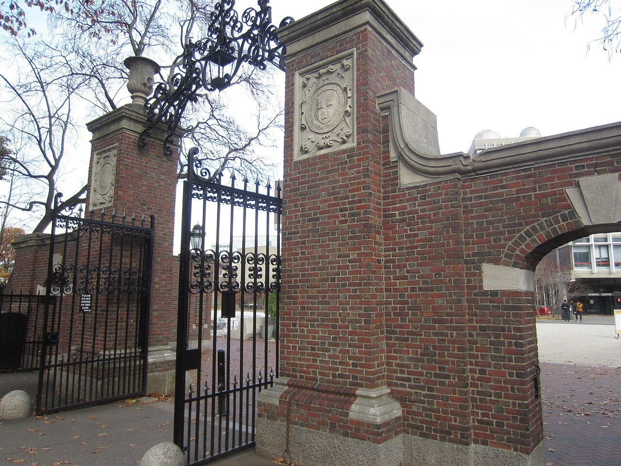A brick gate pier and wrought-iron gate into Harvard Yard