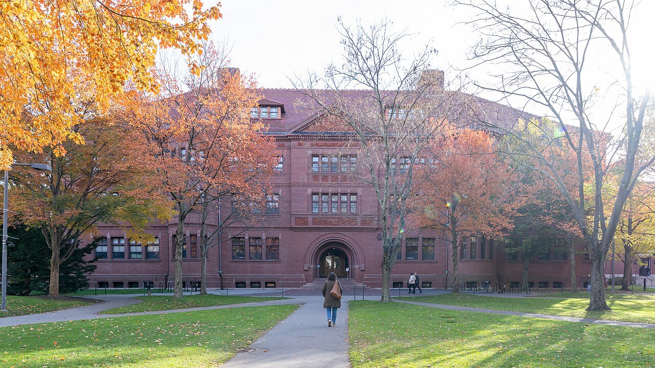 Sever Hall and its round-arched entrance behind autumn trees