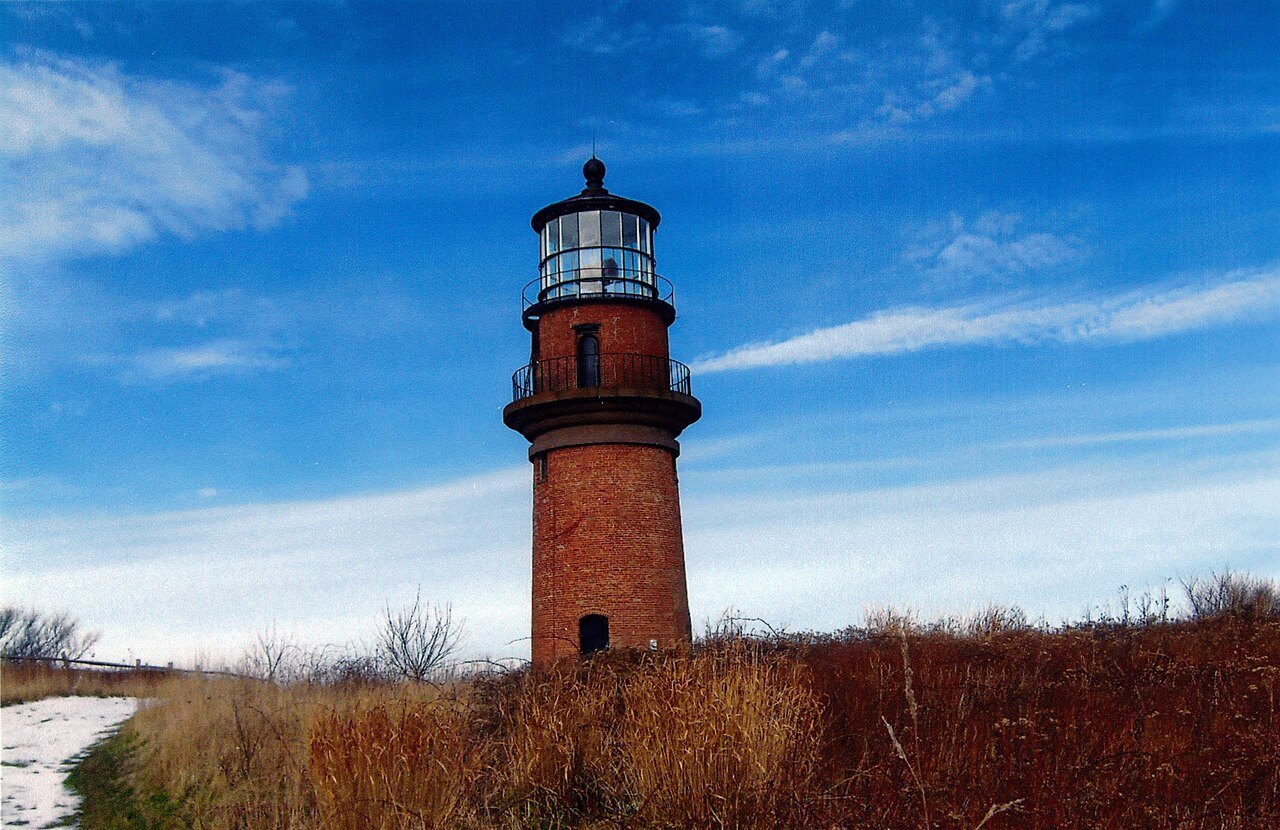 The red-brick Gay Head Light against a deep blue sky