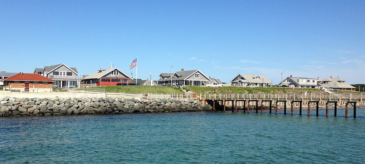 The Oak Bluffs waterfront, a pier running out from the shore below the houses