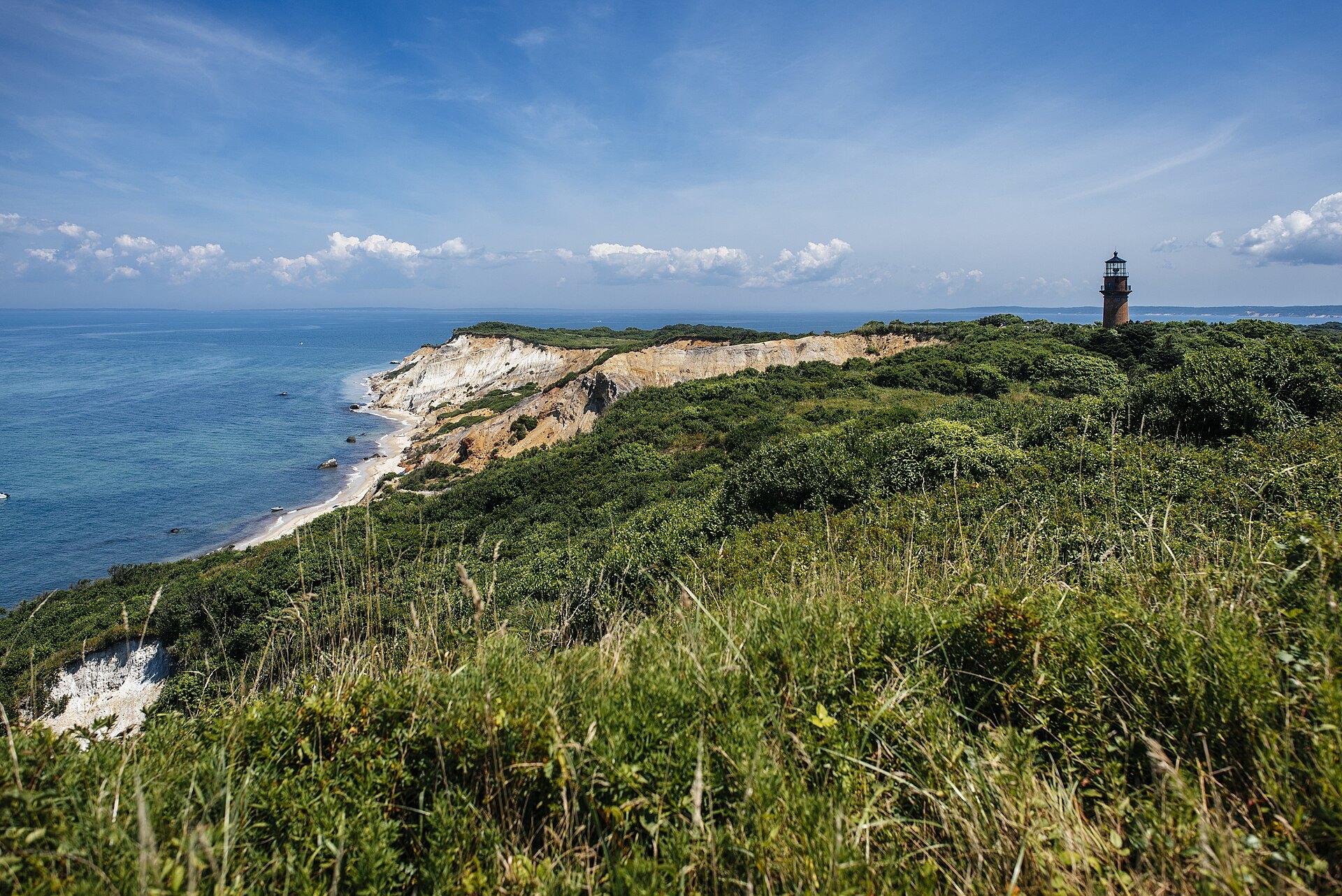 The clay cliffs of Aquinnah above the sea on Martha's Vineyard, with Gay Head Light on the headland