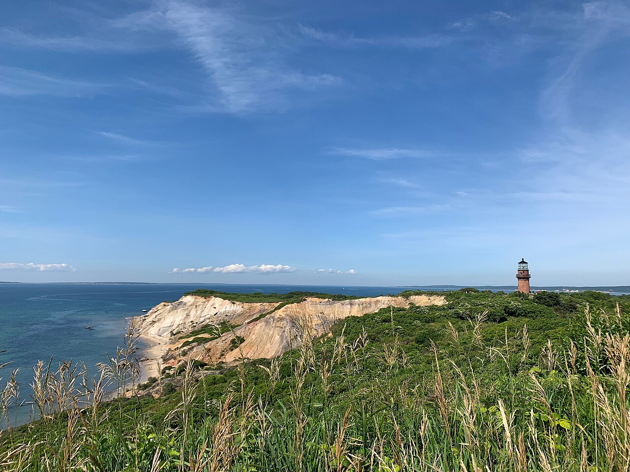The clay cliffs of Aquinnah and Gay Head Light on the headland above the sea