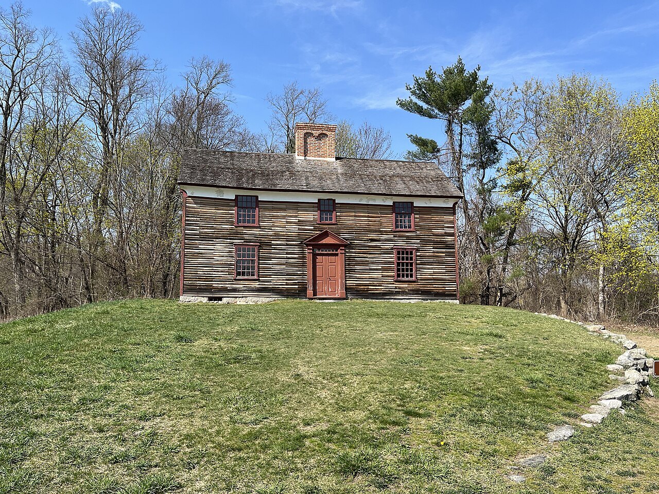 The Captain William Smith House on the Battle Road, a weathered farmhouse on a green rise