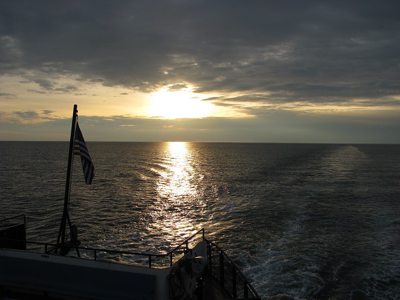 The sun going down over the sound from the stern of a Nantucket ferry