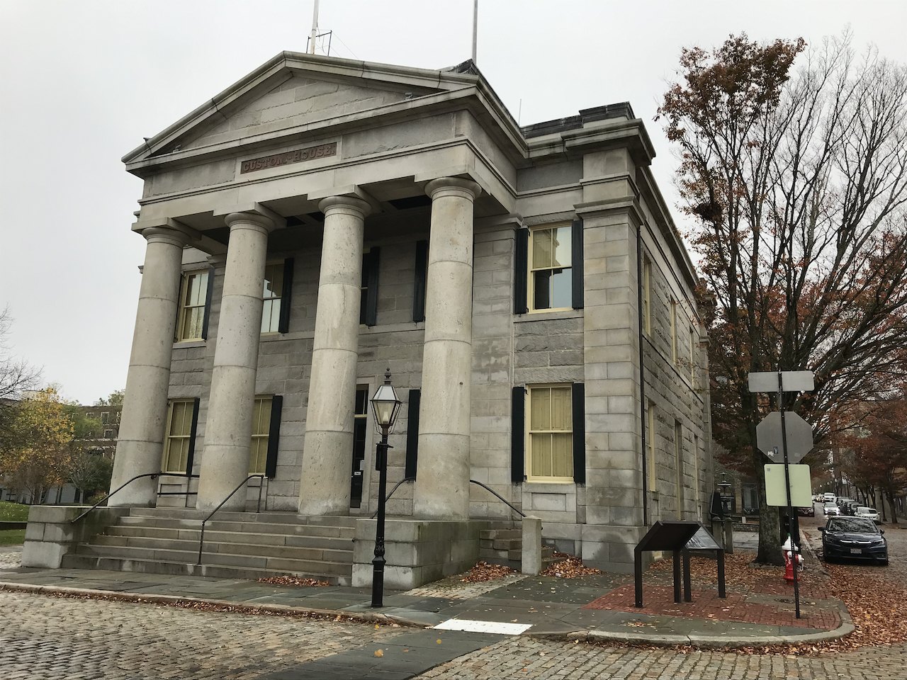 The granite Custom House and its columned portico on a cobbled corner