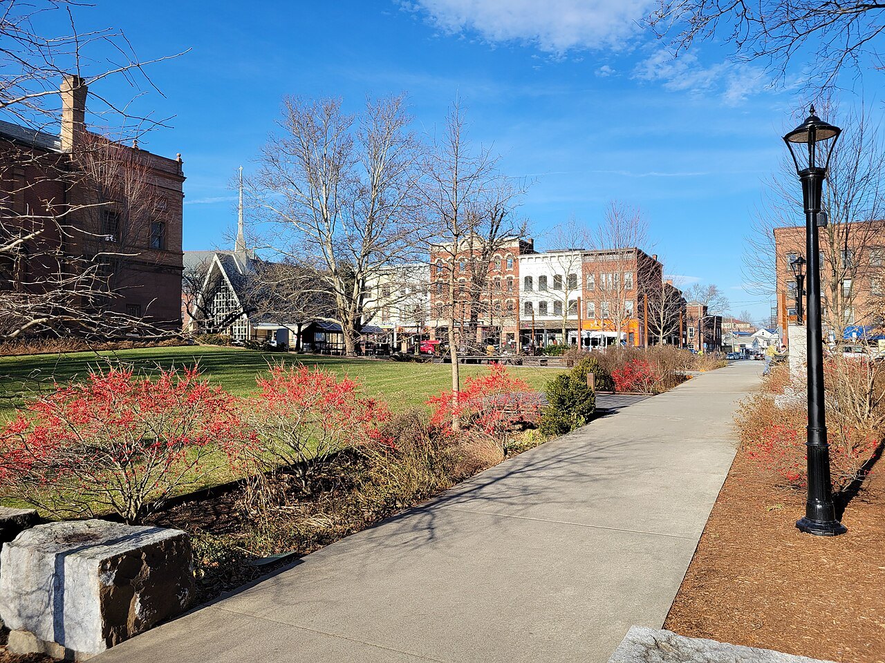 Pulaski Park in the center of town, red shrubs along its path in autumn