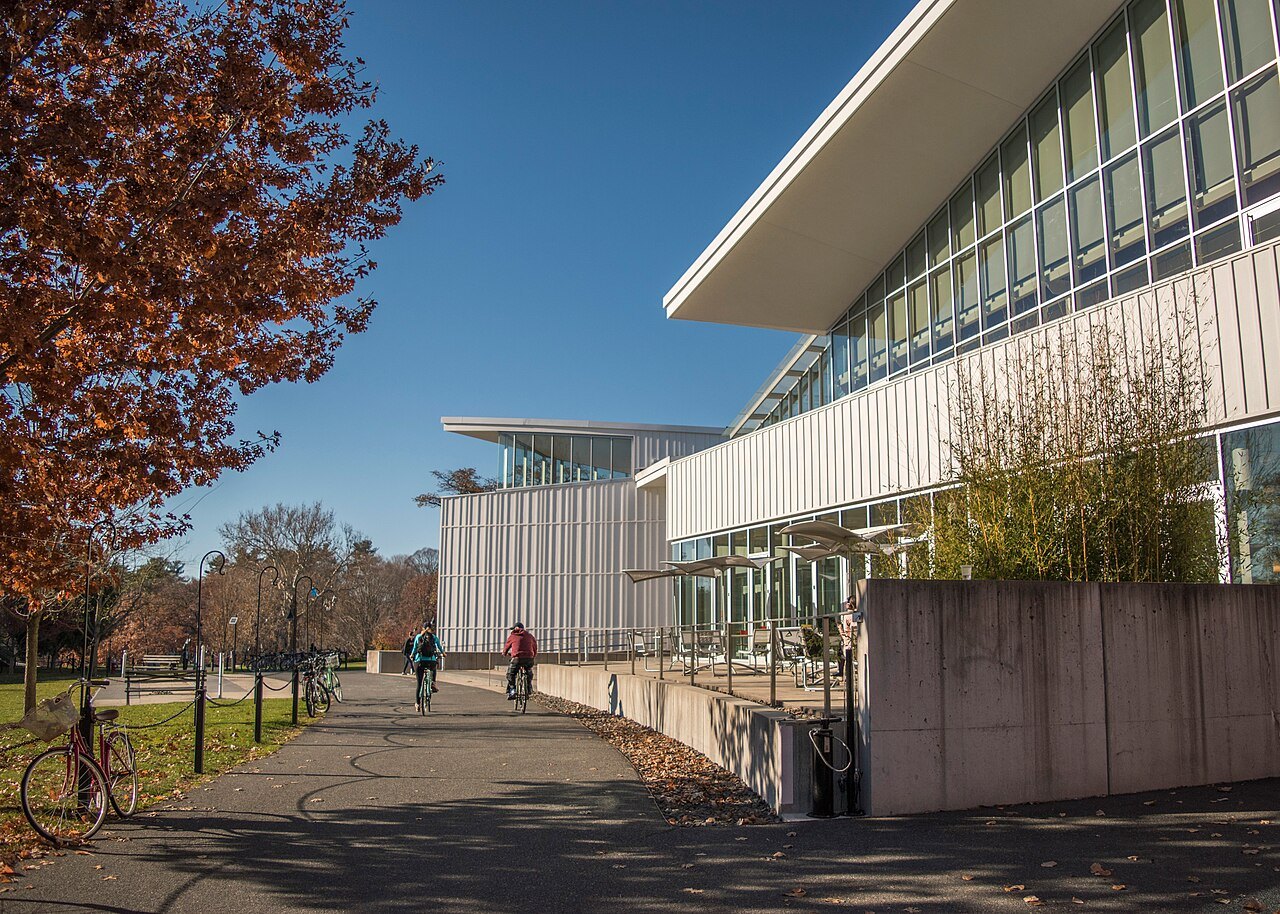 The glass Campus Center at Smith College beside a shady path