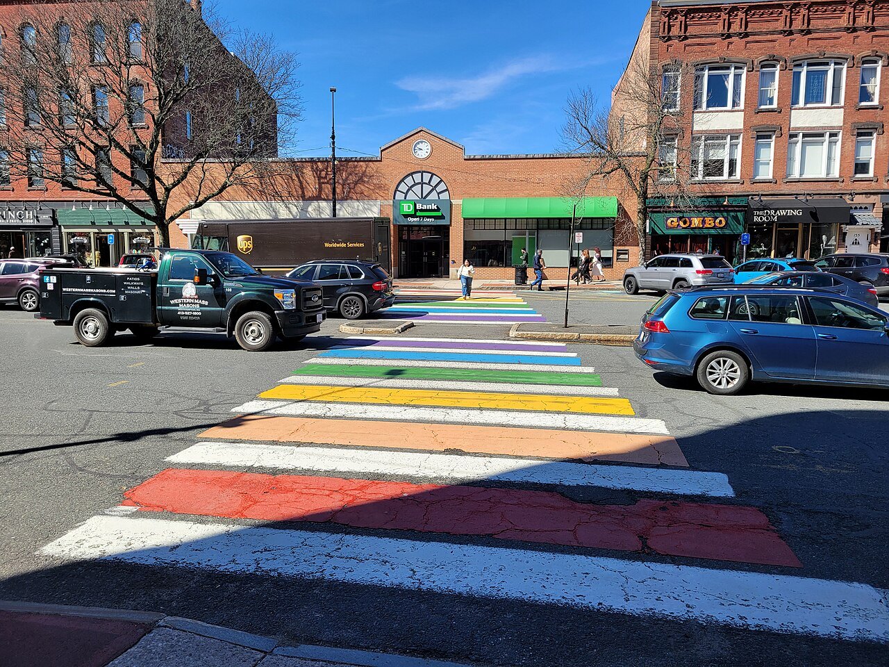 A rainbow crosswalk across a downtown street