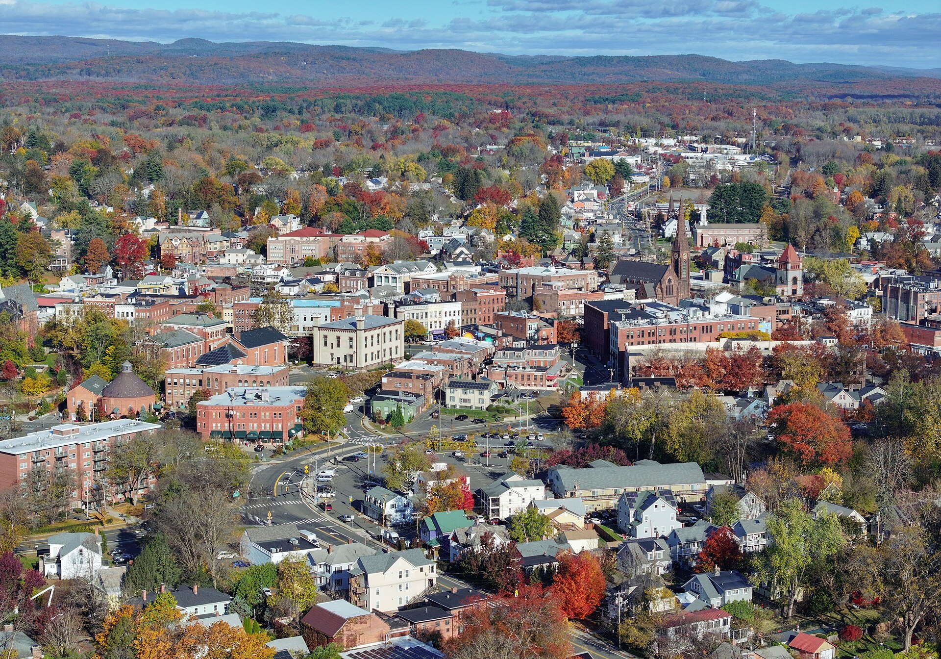 Northampton from the air in autumn, the brick center of town among the colored hills of the valley