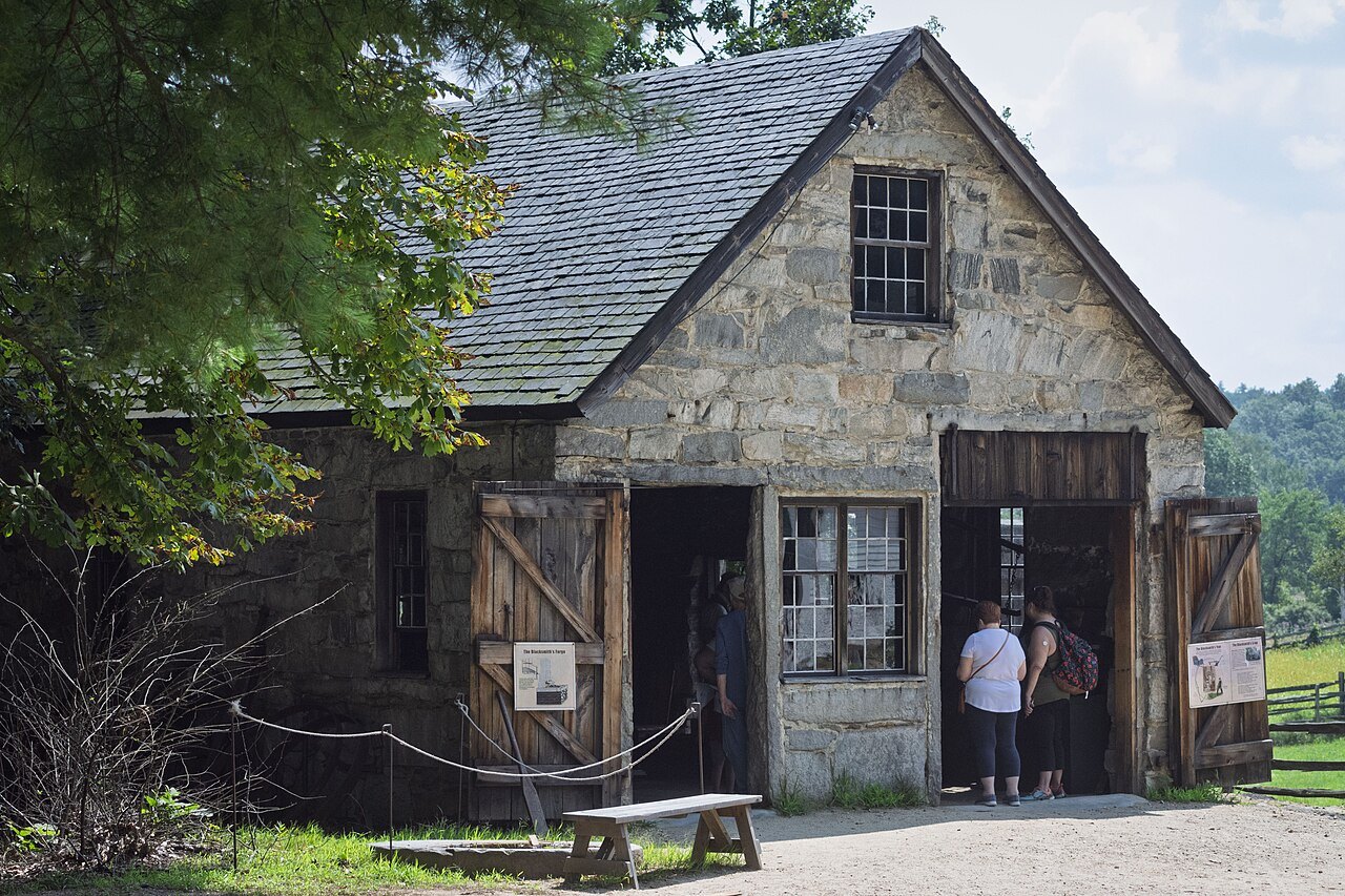 The stone blacksmith shop, its double doors open to visitors
