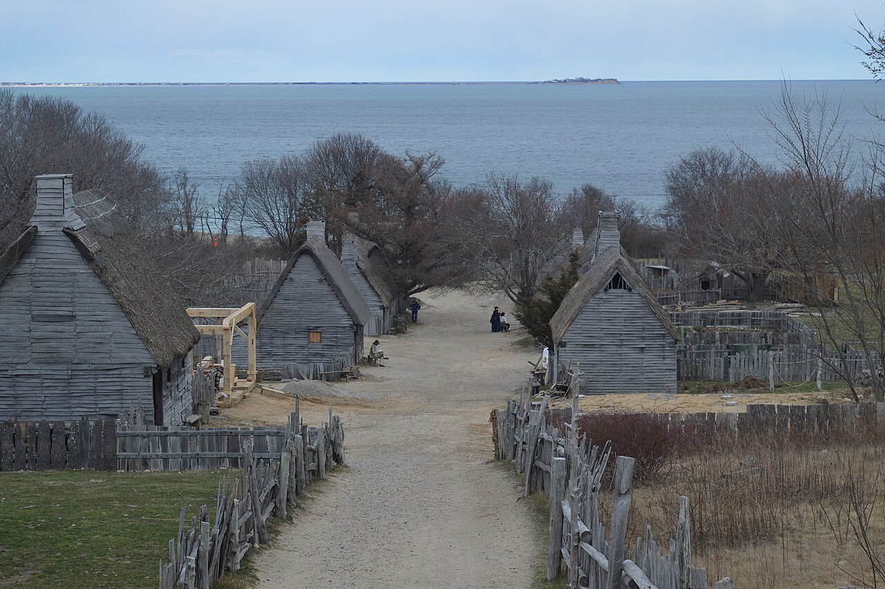 The village in early spring, its thatched houses along the sandy street above the bay