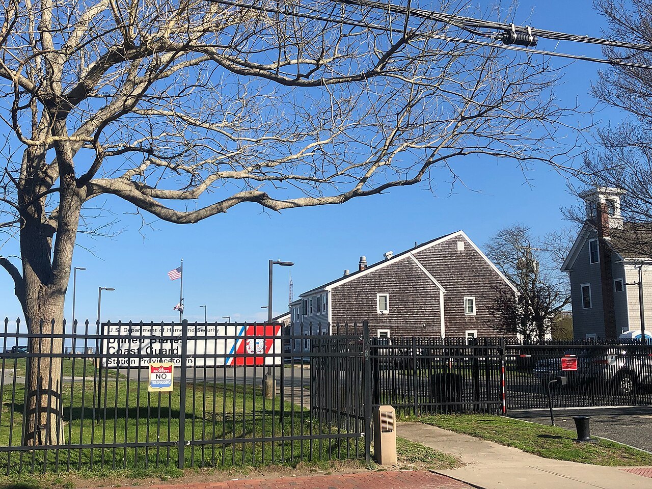 The Coast Guard station in Provincetown behind its fence and a bare tree