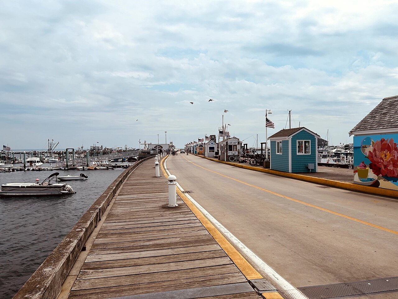 MacMillan Pier running out into the harbor, small huts along its edge