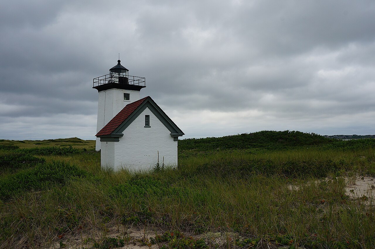Wood End Light, a small white tower and shed among the dune grass